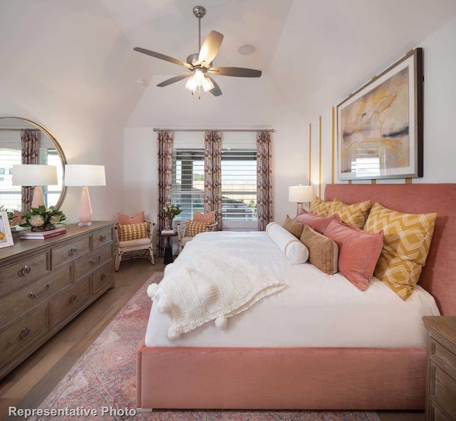 bedroom with hardwood / wood-style flooring, ceiling fan, and lofted ceiling