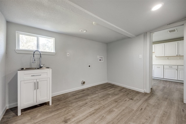 clothes washing area with cabinets, washer hookup, electric dryer hookup, sink, and light hardwood / wood-style floors