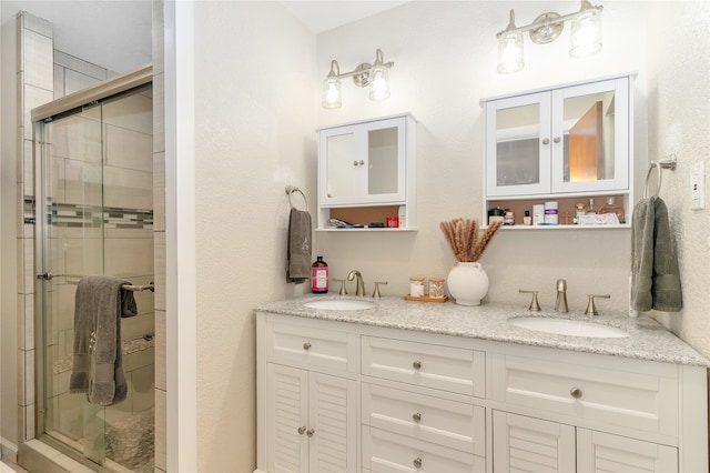 bathroom featuring vanity and an enclosed shower