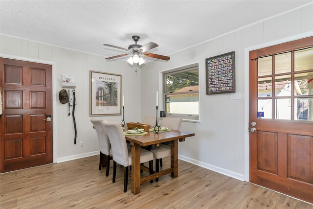 dining area with ceiling fan, light hardwood / wood-style flooring, and crown molding