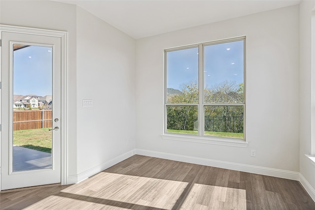 unfurnished living room with a towering ceiling and dark wood-type flooring