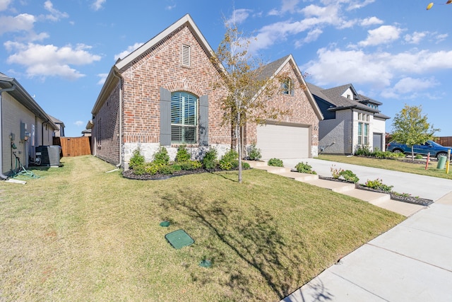 view of front of house with central AC unit, a front lawn, and a garage