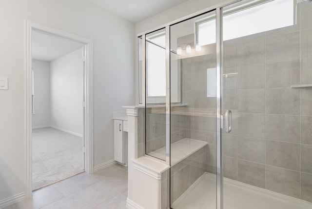 bathroom featuring tile patterned floors, vanity, and an enclosed shower