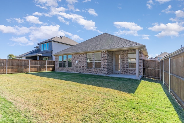 rear view of property featuring a lawn