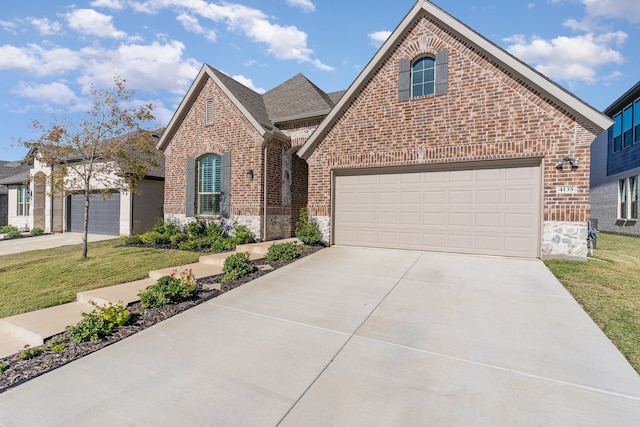 view of property with a front yard and a garage