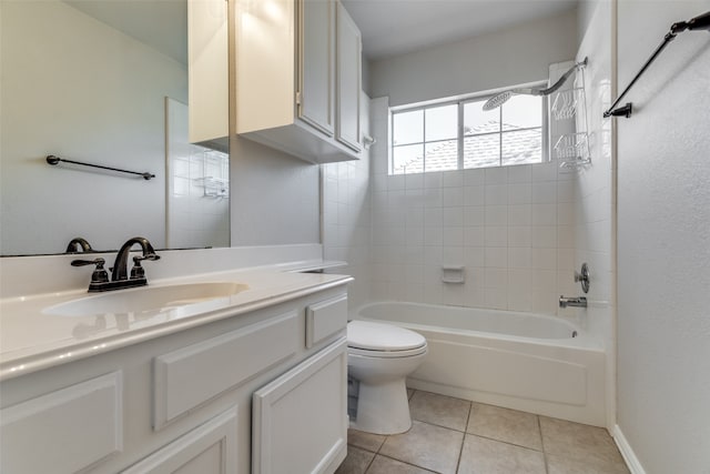 full bathroom featuring toilet, vanity, tile patterned floors, and tiled shower / bath