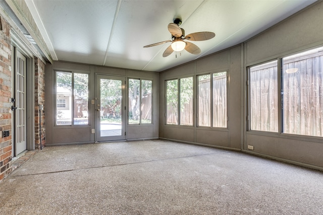 unfurnished sunroom featuring ceiling fan and lofted ceiling