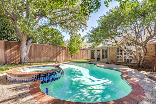 view of swimming pool with an in ground hot tub