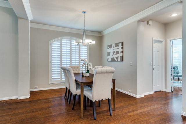 dining area featuring dark hardwood / wood-style floors, crown molding, and an inviting chandelier