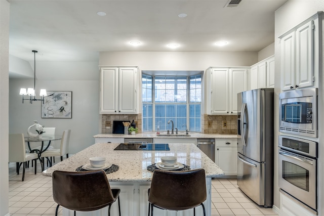 kitchen featuring a center island, white cabinetry, and appliances with stainless steel finishes