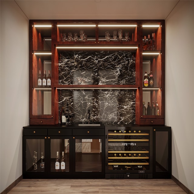 bar featuring light wood-type flooring and beverage cooler