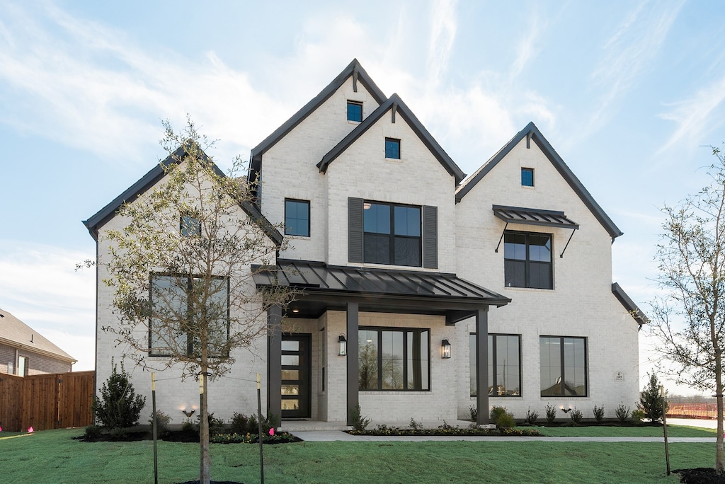 modern farmhouse with a front yard and a porch