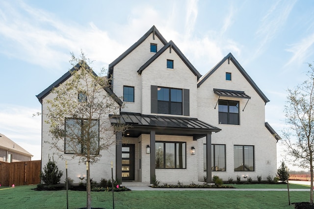 modern farmhouse with a front yard and a porch