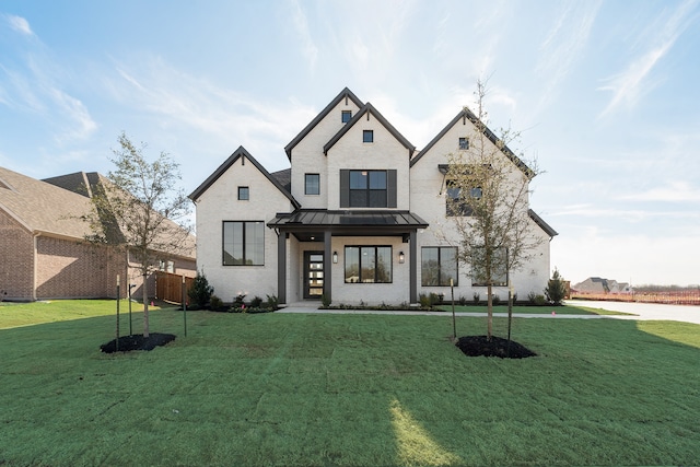 modern inspired farmhouse featuring a front lawn