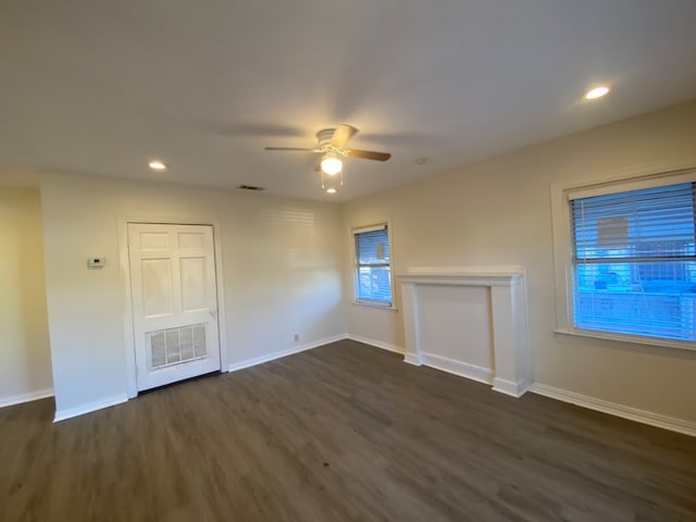 unfurnished room featuring ceiling fan and dark wood-type flooring