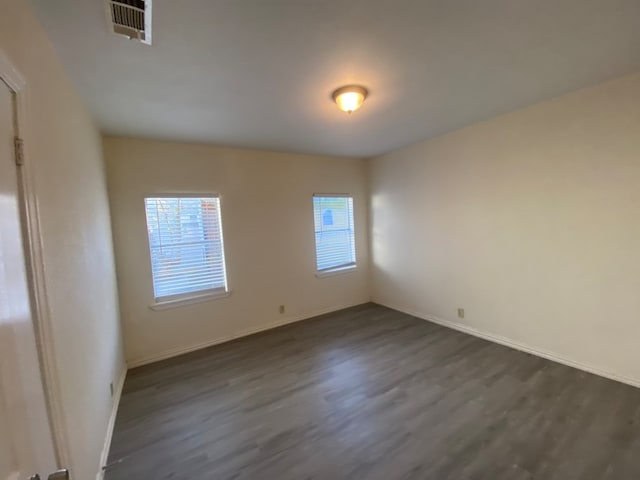 empty room featuring dark hardwood / wood-style flooring