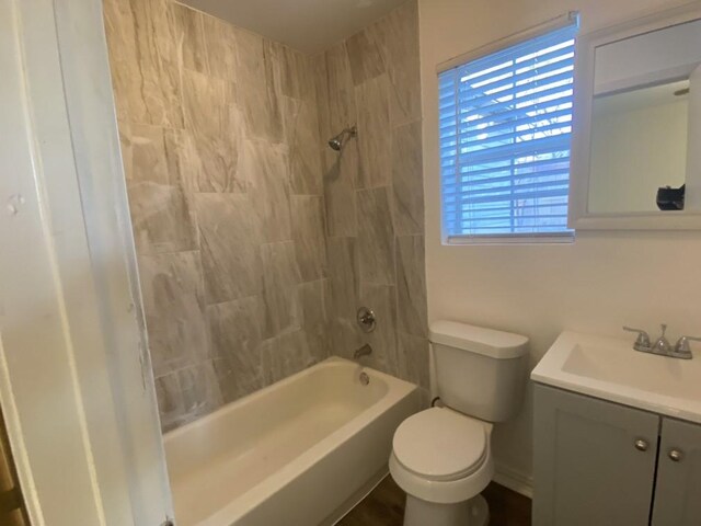 full bathroom featuring vanity, toilet, and tiled shower / bath