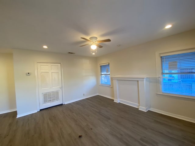 spare room with ceiling fan and dark wood-type flooring