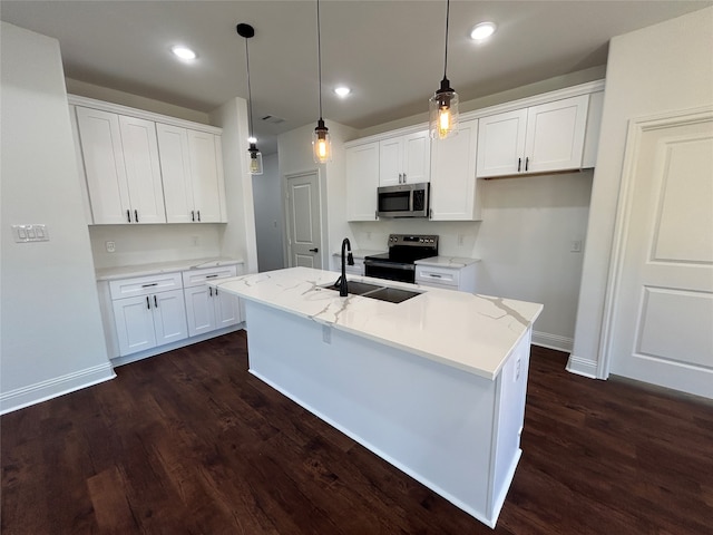 kitchen featuring white cabinets, hanging light fixtures, sink, an island with sink, and appliances with stainless steel finishes