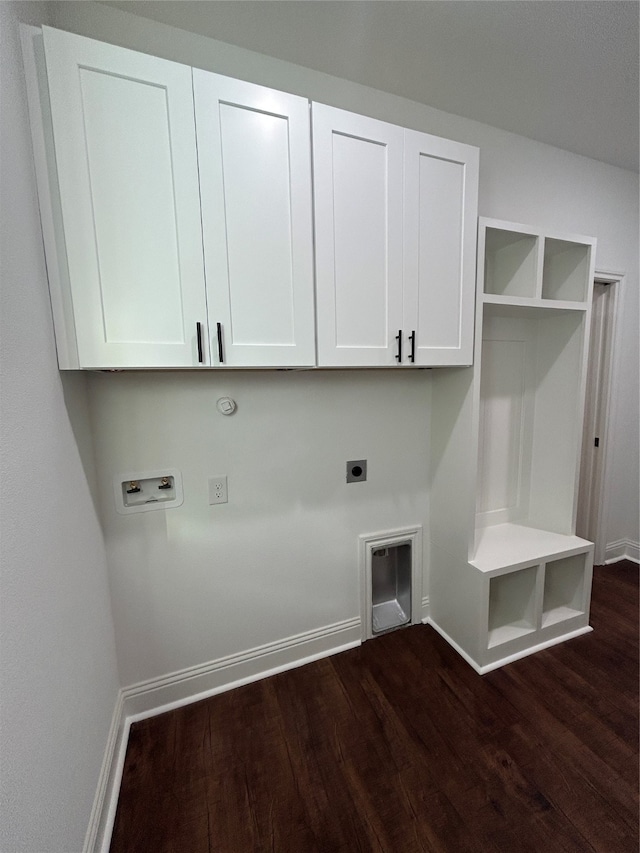 washroom with electric dryer hookup, hookup for a washing machine, cabinets, and dark hardwood / wood-style floors