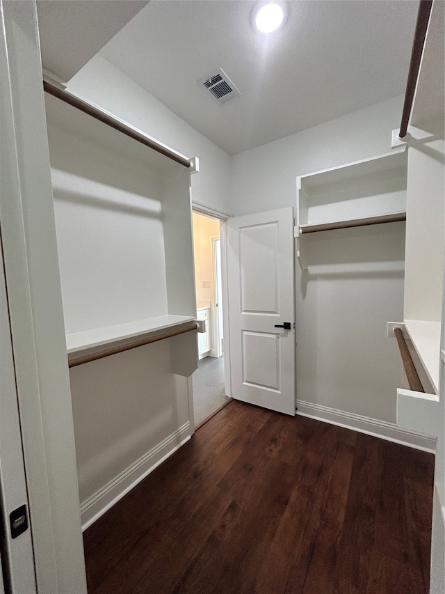 walk in closet featuring dark hardwood / wood-style floors