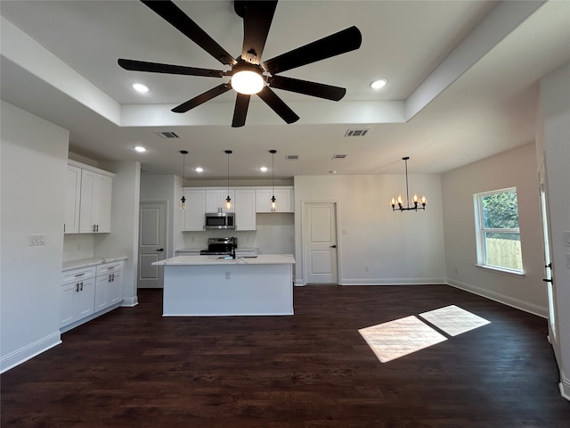 kitchen featuring white cabinetry, an island with sink, appliances with stainless steel finishes, and dark wood-type flooring