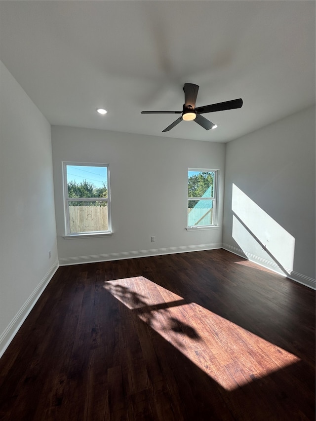 spare room featuring ceiling fan and dark wood-type flooring