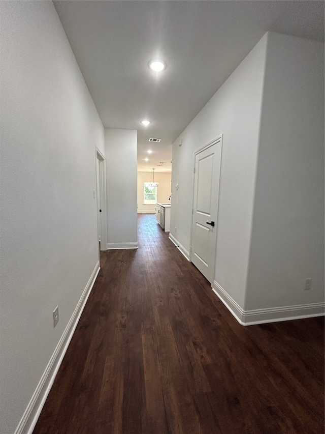 hallway featuring dark hardwood / wood-style flooring