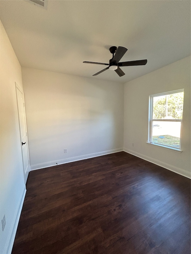 empty room featuring dark hardwood / wood-style flooring and ceiling fan