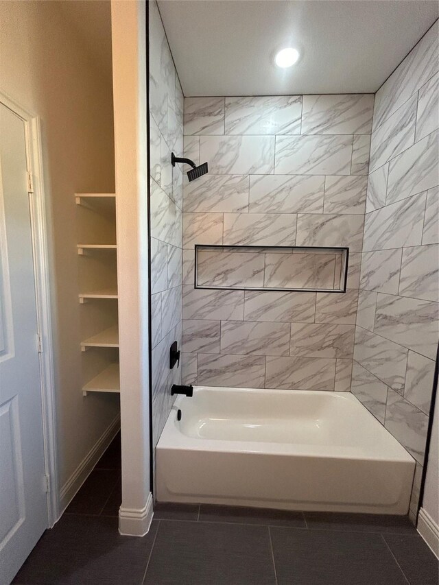 bathroom featuring tile patterned flooring and tiled shower / bath