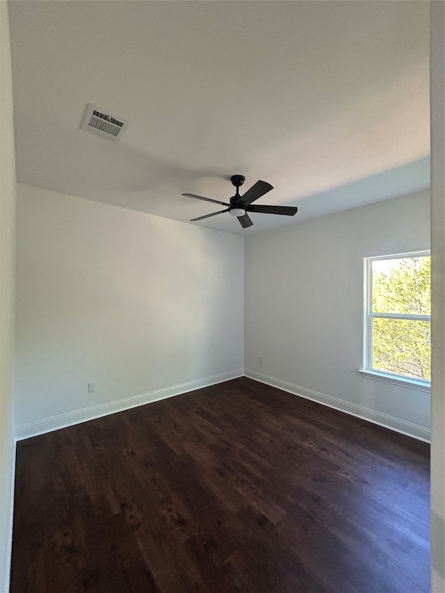 spare room with dark hardwood / wood-style floors and ceiling fan