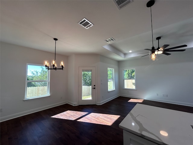 interior space featuring dark hardwood / wood-style flooring and ceiling fan with notable chandelier