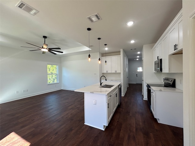 kitchen featuring pendant lighting, sink, dark hardwood / wood-style floors, white cabinetry, and stainless steel appliances