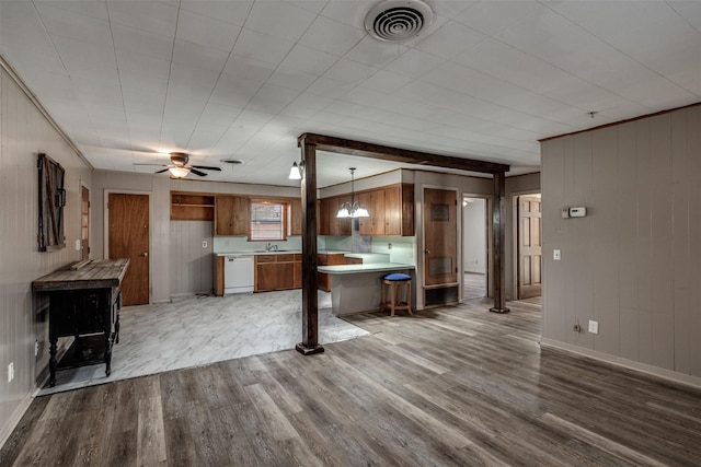 kitchen featuring pendant lighting, white dishwasher, ceiling fan, light wood-type flooring, and a breakfast bar area