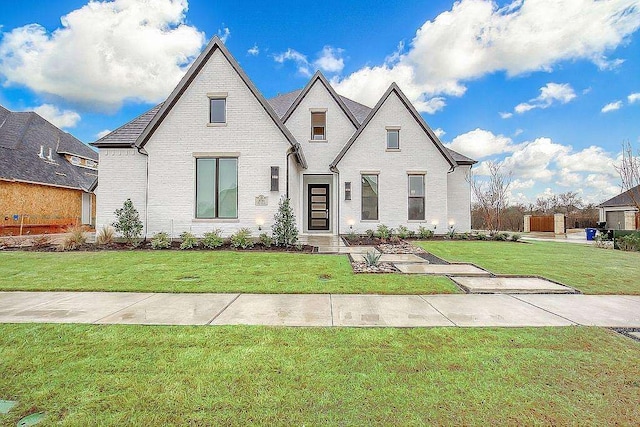 french provincial home featuring a front yard