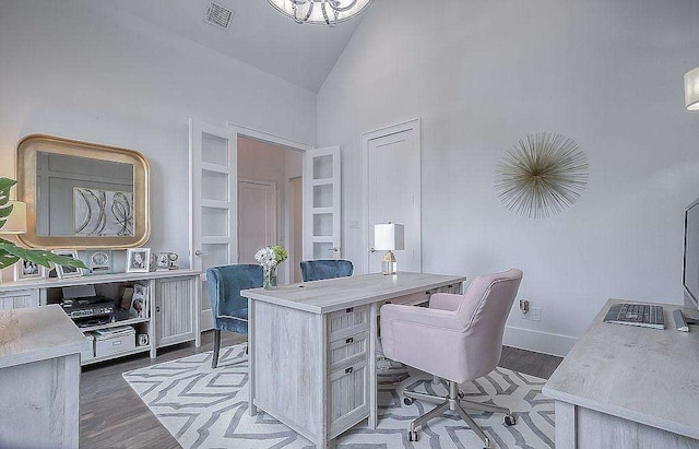 home office with dark wood-type flooring and high vaulted ceiling