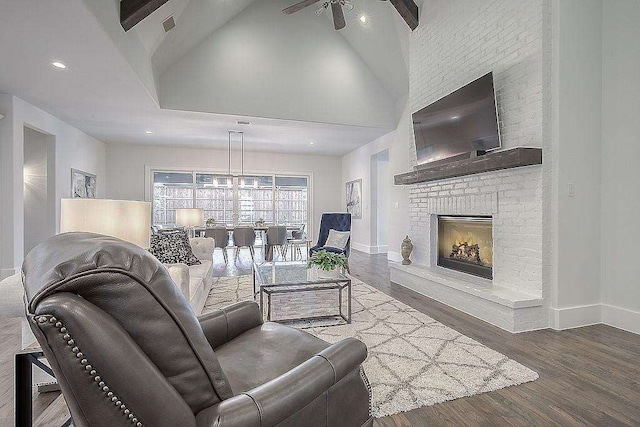 living room featuring ceiling fan, a fireplace, high vaulted ceiling, and hardwood / wood-style flooring