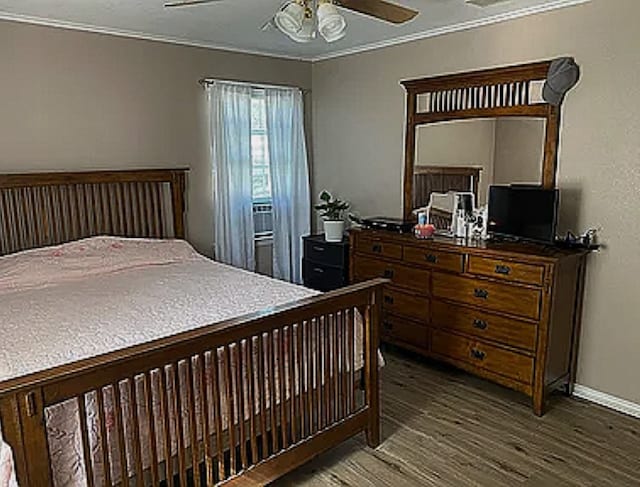 bedroom featuring ceiling fan, dark wood-type flooring, and ornamental molding