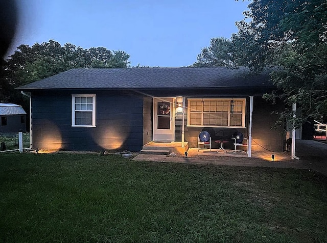 ranch-style home with a yard