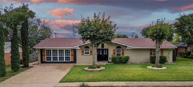 ranch-style house with a yard