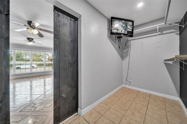 interior space with ceiling fan