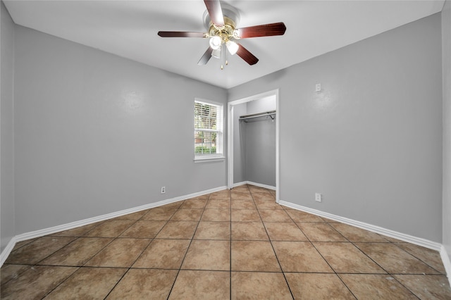 unfurnished bedroom with tile patterned flooring, a closet, and ceiling fan