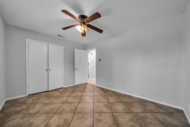 unfurnished bedroom featuring tile patterned flooring and ceiling fan