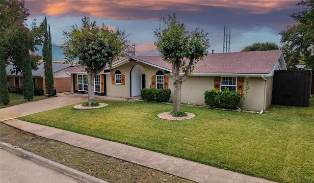 ranch-style home featuring a yard