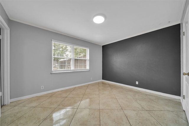 spare room featuring ornamental molding and light tile patterned flooring