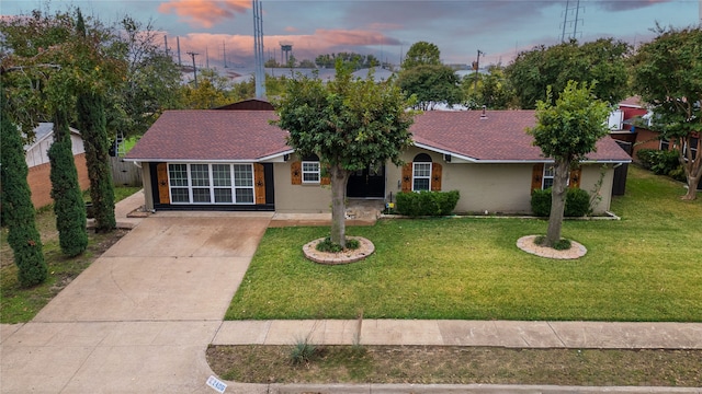 ranch-style home with a yard