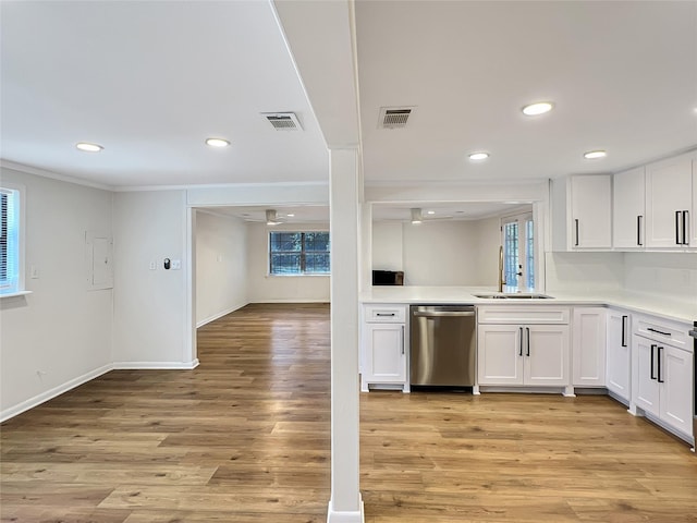 kitchen with white cabinets, stainless steel dishwasher, visible vents, and light wood-style floors