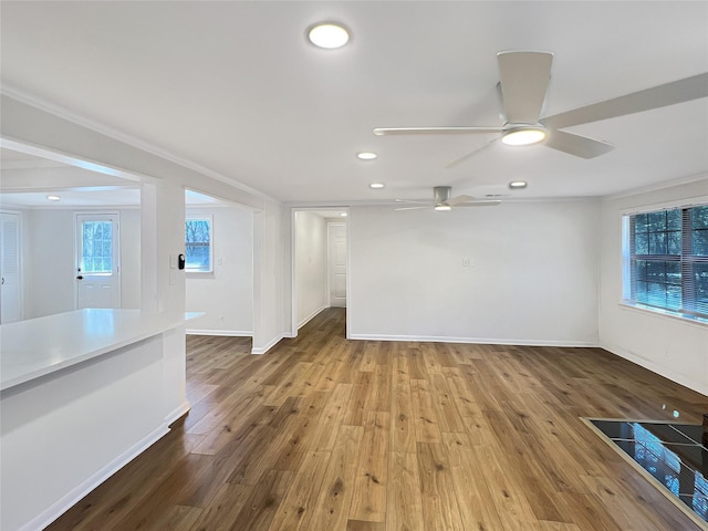 interior space with ceiling fan, recessed lighting, wood finished floors, and baseboards