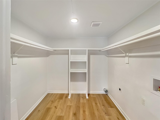 spacious closet featuring light wood-type flooring and visible vents