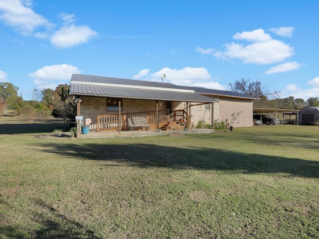 rear view of property with a yard